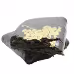 Close-up of high-quality cannabis hash with gold details, showcasing a dense, aromatic concentrate for cannabis enthusiasts. Perfect for seasoned users seeking potent, pure cannabis extracts.