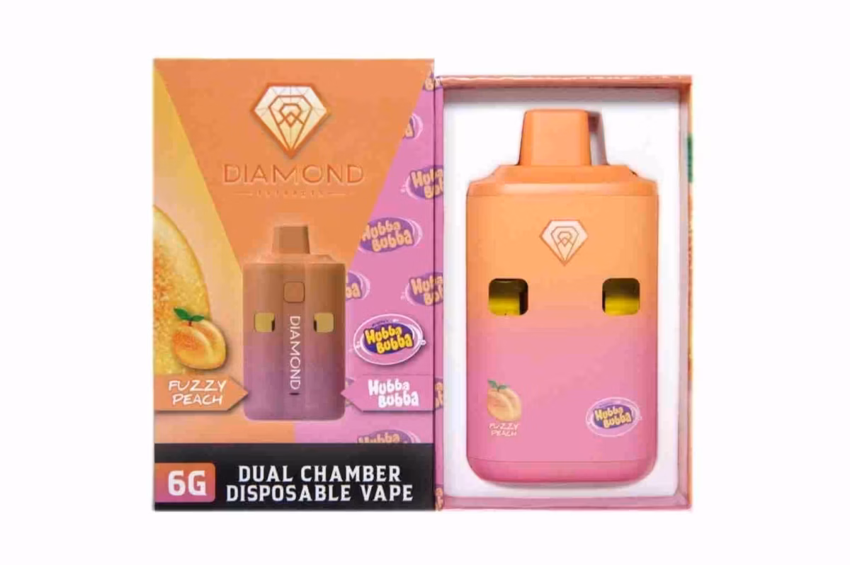 1. Bright peach-colored disposable vape with dual chambers, signature Diamond logo, and vibrant packaging featuring a peach illustration, designed for cannabis concentrate and THC oil consumption.
