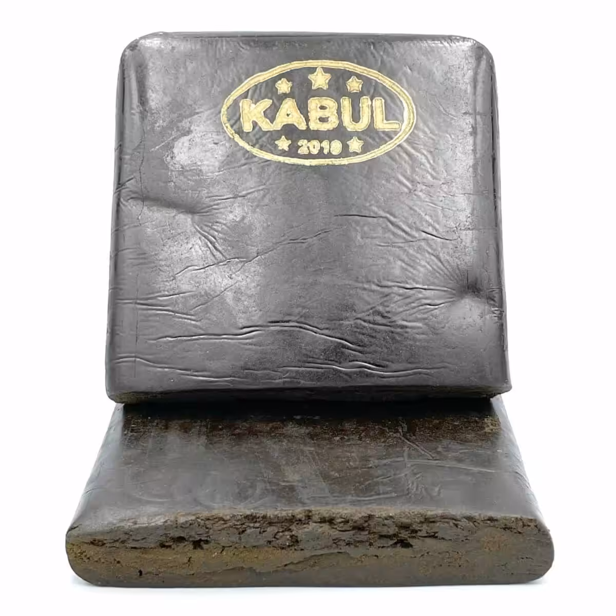 Alt text: Solid Kabul hash block with gold stamping, showing detailed texture and dense appearance, typically used for aromatic and potent cannabis concentrates.