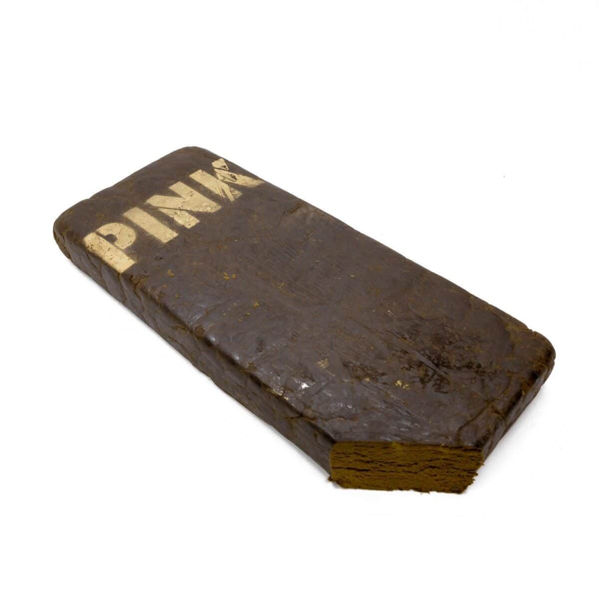 A pressed hash brick with "PIN" printed on the surface, showcasing classic cannabis concentrate form. Perfect for seasoned consumers seeking potent marijuana concentrates.