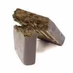 Close-up of compressed cannabis concentrate in a stone-like form. Perfect for medicinal and recreational use, highlighting premium quality Canadian cannabis products.