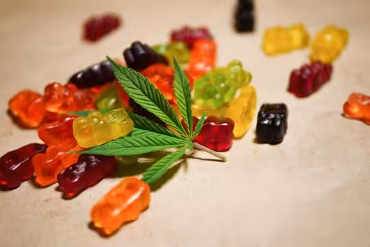 Bright, colorful cannabis gummies with a green leaf in the center, highlighting cannabis edible products. Perfect for those seeking high-quality cannabis edibles in Canada.