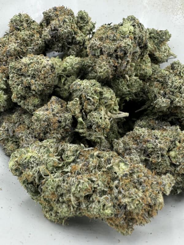 High-quality cannabis flower with frosty trichomes and vibrant green buds. Perfect for relaxing, premium quality, and heavy effects.
