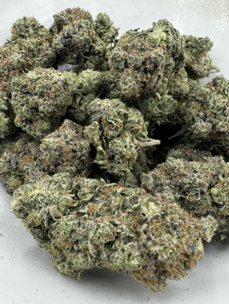 High-quality cannabis flower with frosty trichomes and vibrant green buds. Perfect for relaxing, premium quality, and heavy effects.