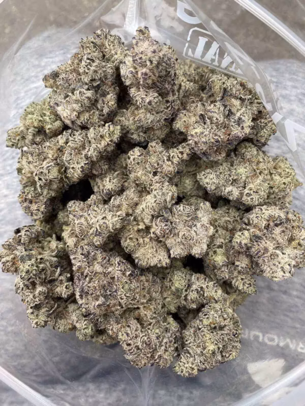 Frosty, high-quality cannabis buds with vibrant purple hues and dense trichomes for optimal potency. Perfect for connoisseurs seeking top-tier marijuana flower.
