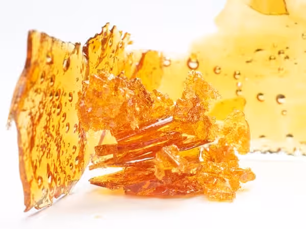 Golden cannabis shatter and concentrates with vibrant amber color, highlighting potency and purity from trusted Canadian dispensaries.