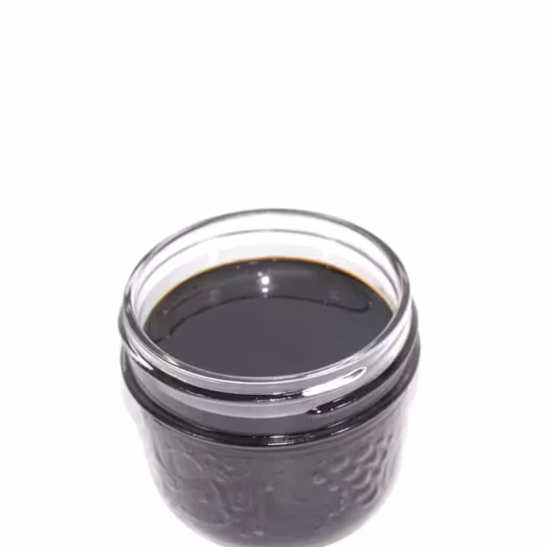 Rich black cannabis concentrate in a glass jar, premium quality for adult use, high potency, best selection from trusted dispensaries in Canada, perfect for medicinal or recreational cannabis enthusiasts.