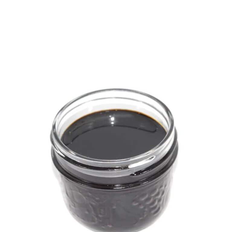 Rich black cannabis concentrate in a glass jar, premium quality for adult use, high potency, best selection from trusted dispensaries in Canada, perfect for medicinal or recreational cannabis enthusiasts.