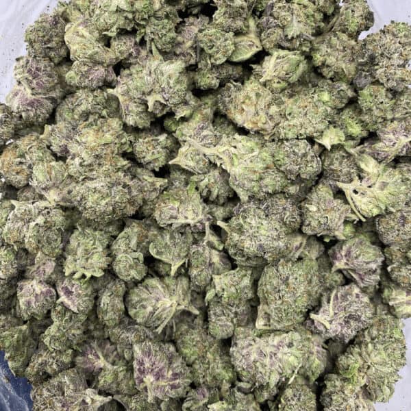 Close-up of high-quality cannabis buds with frosty trichomes and vibrant green-purple hues, ideal for cannabis connoisseurs and enthusiasts.