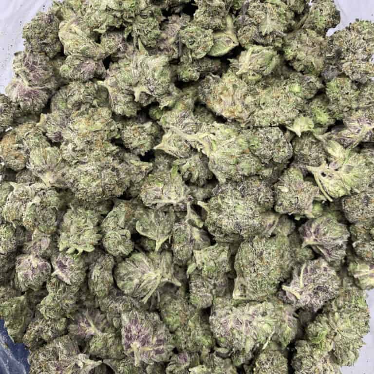 Close-up of high-quality cannabis buds with frosty trichomes and vibrant green-purple hues, ideal for cannabis connoisseurs and enthusiasts.