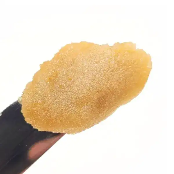 Close-up of golden cannabis concentrate dab on a dab tool, showcasing high-quality extract, potent and pure marijuana concentrate, ideal for medicinal and recreational use.