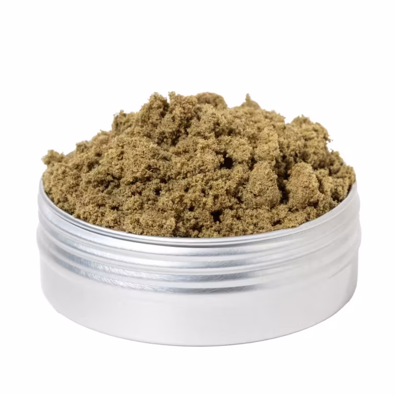 Close-up of high-quality cannabis kief in a metal container, showcasing fine, aromatic trichomes essential for experienced users looking for potent cannabis concentrates.